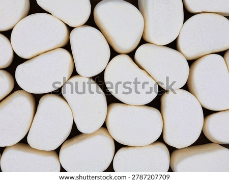 
Group of white marshmallows in top view. Soft, spongy candies. Marshmallow background.