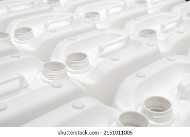 A group of white plastic jerry cans in a factory