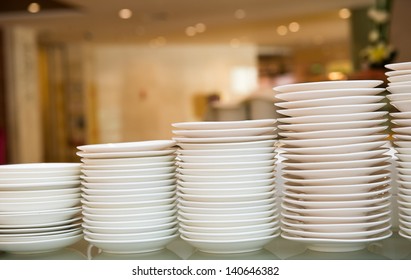 Group Of White Plates Stacked Together.