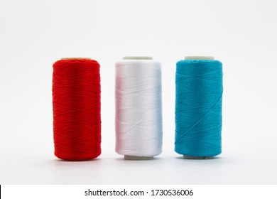 Group of whole haberdashery item colorful thread spools isolated on white background. Coloured threads. Colorful bobbin thread. 