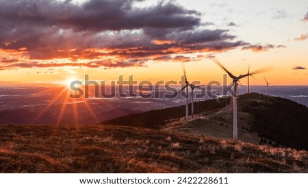 A group of wind mills early in the morning while sunrise in Austria