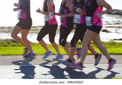 Group of woman compete in the race on coastal road. Blurred motion - Powered by Shutterstock