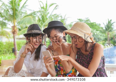 group of woman friend looking to smart phone and laughing with happiness face ,relaxing vacation of people lifestyle