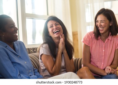 Group Of Woman Laughing And Talking At Home