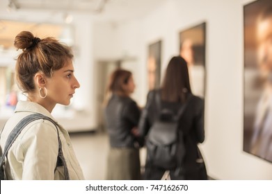 Group Of Woman Looking At Modern Painting In Art Gallery. Abstract Painting