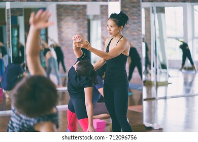 Group Women Asian Doing Stretching Yoga Hot Exercises With Instructor In Studio