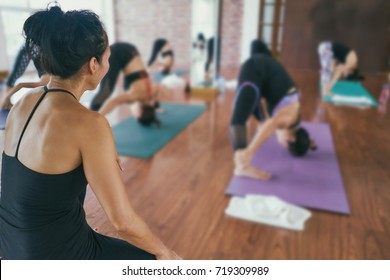 Group Women Asian Doing Stretching Yoga Hot Exercises With Instructor In Studio