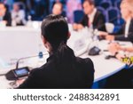 Group of women in business suits at round table, board meeting, roundtable talking and discussing at conference, female politicians and entrepreneurs, businesswomen dialog on forum, panel discussion