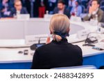 Group of women in business suits at round table, board meeting, roundtable talking and discussing at conference, female politicians and entrepreneurs, businesswomen dialog on forum, panel discussion