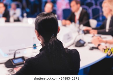 Group of women in business suits at round table, board meeting, roundtable talking and discussing at conference, female politicians and entrepreneurs, businesswomen dialog on forum, panel discussion