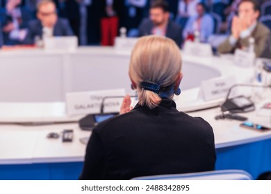 Group of women in business suits at round table, board meeting, roundtable talking and discussing at conference, female politicians and entrepreneurs, businesswomen dialog on forum, panel discussion