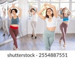 Group of women dancing oriental belly dancing in studio