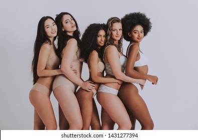 Group of women with different body and ethnicity posing together to show the woman power and strength. Curvy and skinny kind of female body concept