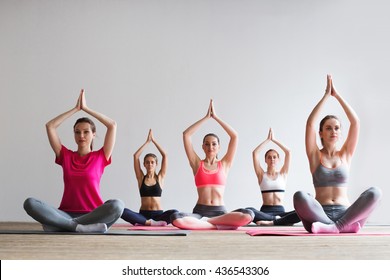 Group Of Women Doing Yoga In A Fitness Gym.