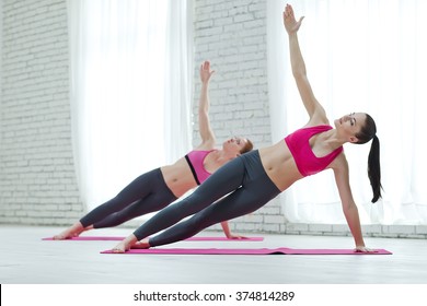 Group Of Women Doing Yoga Indoors