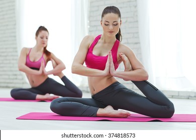 Group Of Women Doing Yoga Indoors