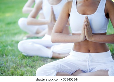 Group Of Women Doing Yoga At Park