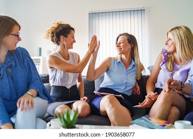 Group Of Women Female Only Colleagues Or Friends Working Together On Project Sitting On Sofa Bed In Room Or At Work - Millennial Entrepreneurs Having Meeting Brainstorming Female Empowerment Concept