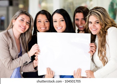 Group of women holding a banner ad and smiling - Powered by Shutterstock