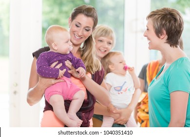 Group of women learning how to use baby slings for mother-child bonding