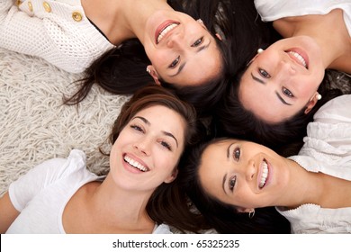 Group Of Women Lying On The Floor And Smiling