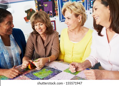 Group Of Women Making Quilt Together