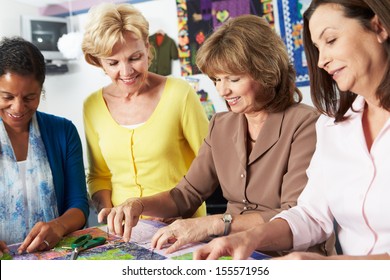 Group Of Women Making Quilt Together