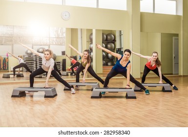 Group Of Women Making Step Aerobics In The Fitness Class