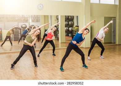 Group of women making stretching aerobics in the fitness class