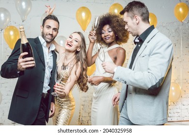 Group of women and men celebrating with champagne