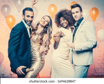 Group of women and men celebrating new years eve or a birthday with champagne