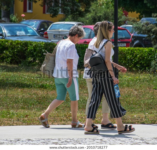 Group of women on the street. Street\
photography. Romania, Orsova. July, 18,\
2021