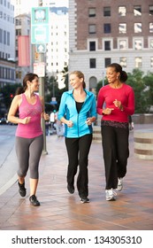 Group Of Women Power Walking On Urban Street