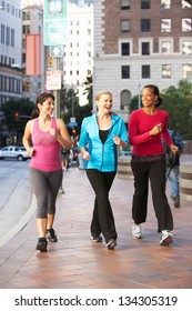 Group Of Women Power Walking On Urban Street