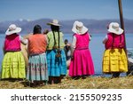 group of women saying goodbye to the tourists on the floating islands of Lake Titicaca, near to Puno - Peru