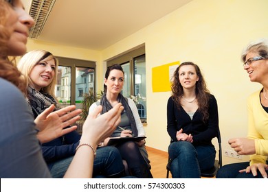 Group Of Women Sitting In A Circle, Discussing