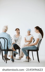 Group Of Women Sitting Together During Psychotherapy With Senior Counselor