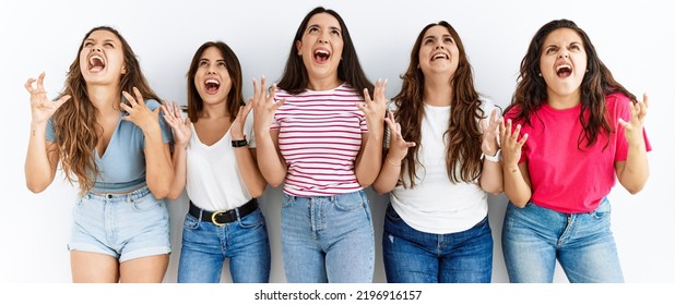 Group Of Women Wearing Casual Clothes Standing Over Isolated Background Crazy And Mad Shouting And Yelling With Aggressive Expression And Arms Raised. Frustration Concept. 