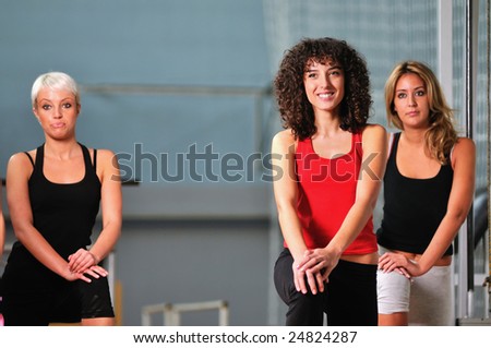 Similar – Close up front portrait of three young and middle age athletic women in sportswear in gym over dark background, looking at camera