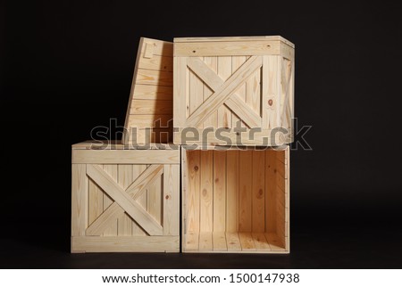 Group of wooden crates on black background