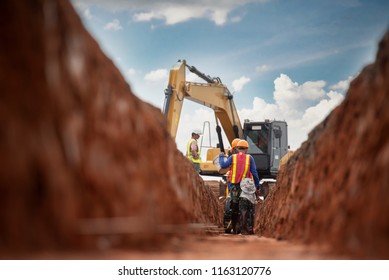 Group worker   construction engineer wear safety uniform excavation water drainage at construction site