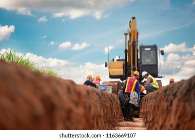 Group of worker and construction engineer wear safety uniform excavation water drainage at construction site - Shutterstock ID 1163669107