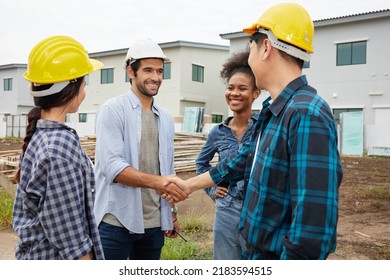 Group Of Workers Or Architect Shaking Hands Together At Construction Site