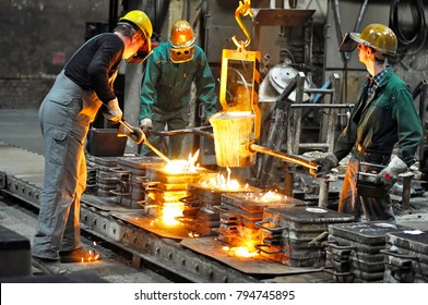 Group of workers in a foundry at the melting furnace - production of steel castings in an industrial company  - Shutterstock ID 794745895