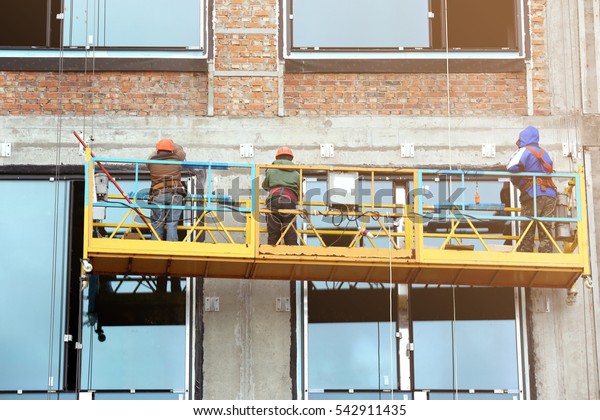 Group of workers installing\
windows