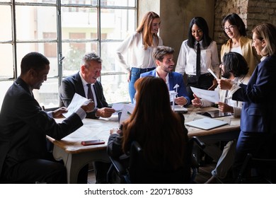 Group Of Workers Meeting In Company Board Room Discussing And Making Decisions