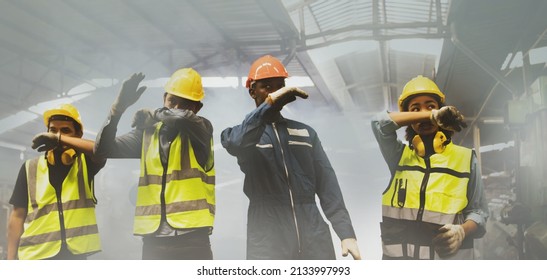 Group workers of men and women covering their noses with their hands for safety, suffocating due to an industrial fire accident. They walked out of the scene consciously before they were harmed. - Shutterstock ID 2133997993