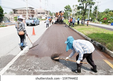 Group Of Workers Working On Asphalt Paving With Para Slurry Seal Truck On Road Renovation