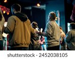 A group of worshippers with hands raised in prayer during an altar call at a church service, expressing faith and devotion. Capturing a powerful communal moment of spirituality and worship.