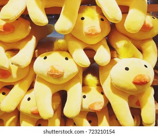Group of yellow duck plush toy in gift shop.